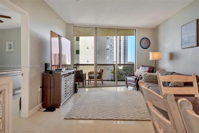 living room with light tile patterned flooring and a wall of windows