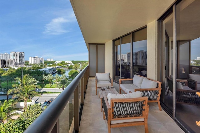 balcony featuring an outdoor hangout area and a water view