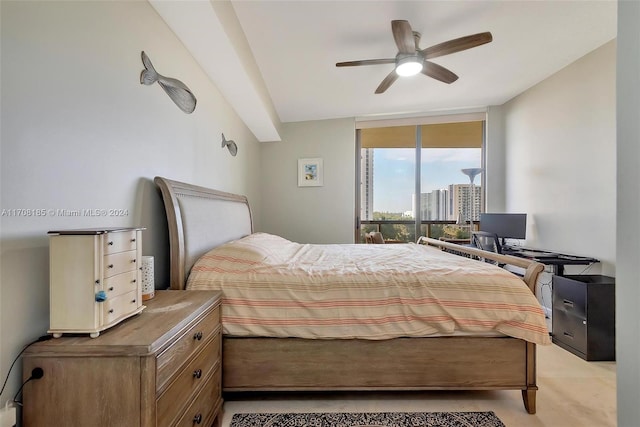 bedroom featuring expansive windows and ceiling fan