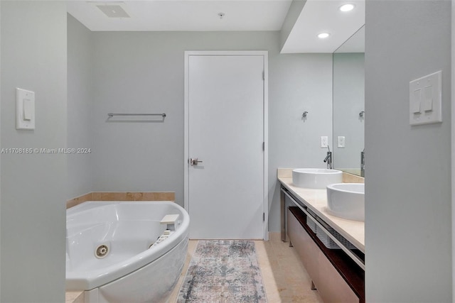 bathroom featuring vanity, a tub to relax in, and tile patterned floors