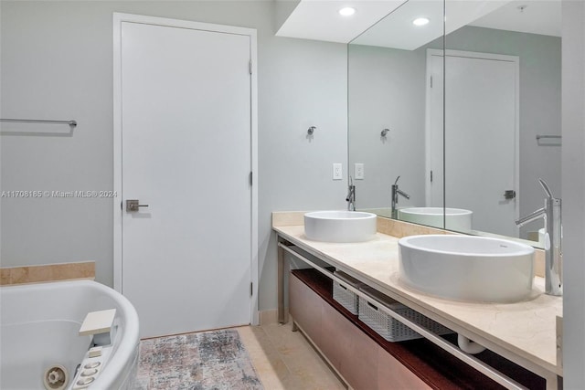 bathroom featuring vanity, tile patterned floors, and a bathing tub