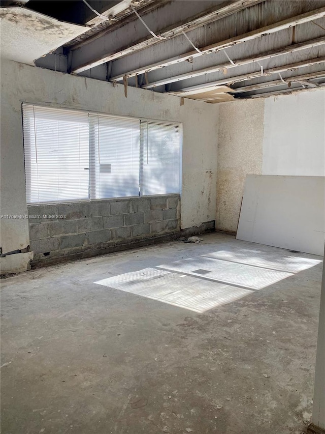 unfurnished room featuring concrete floors