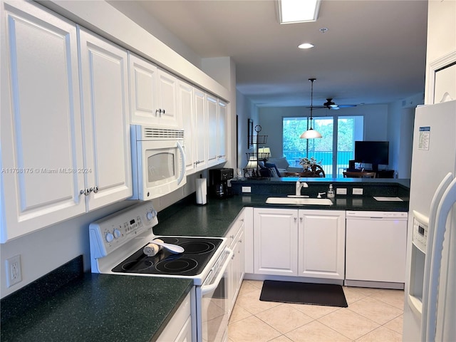 kitchen with white appliances, ceiling fan, sink, light tile patterned floors, and white cabinets