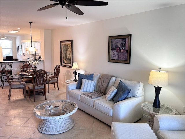 living room featuring light tile patterned floors and ceiling fan