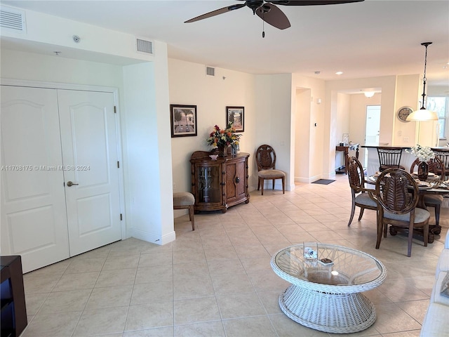 living room featuring ceiling fan and light tile patterned flooring