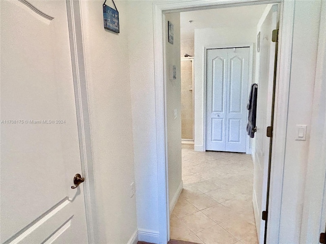 corridor featuring light tile patterned floors