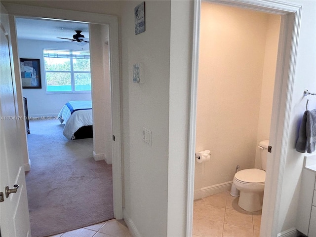 bathroom featuring tile patterned flooring, ceiling fan, and toilet