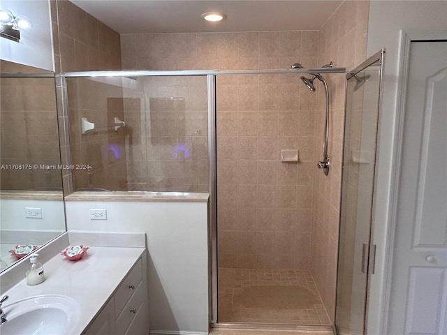 bathroom featuring vanity and a shower with shower door