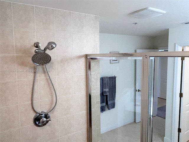 bathroom with a shower with door