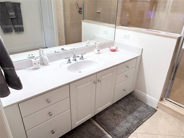 bathroom featuring tile patterned floors, vanity, and a shower with shower door