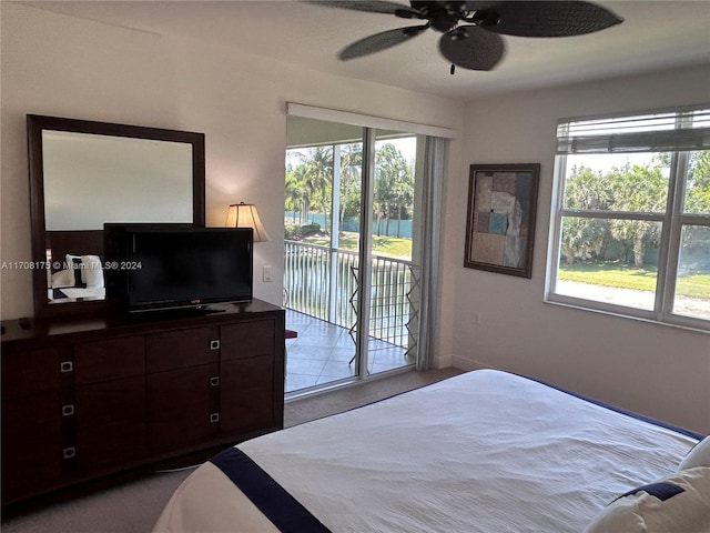 bedroom featuring ceiling fan, access to outside, and multiple windows