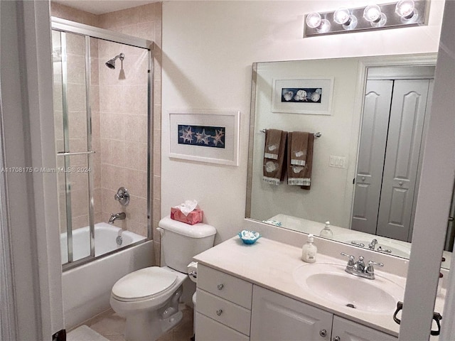 full bathroom with tile patterned floors, vanity, toilet, and shower / bath combination with glass door