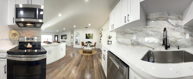 kitchen featuring decorative backsplash, white cabinetry, sink, and appliances with stainless steel finishes