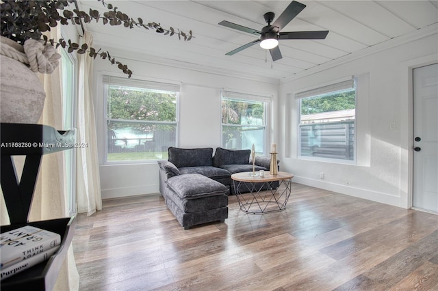 living room with ceiling fan, crown molding, and hardwood / wood-style flooring