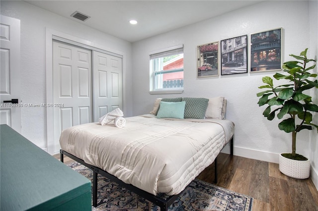 bedroom featuring dark hardwood / wood-style flooring and a closet