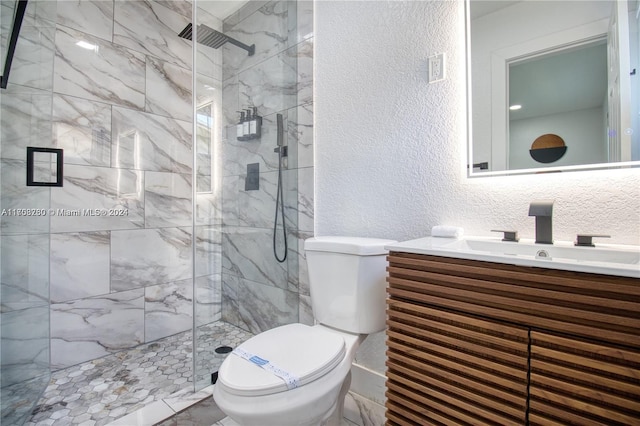 bathroom with vanity, a shower with shower door, and toilet