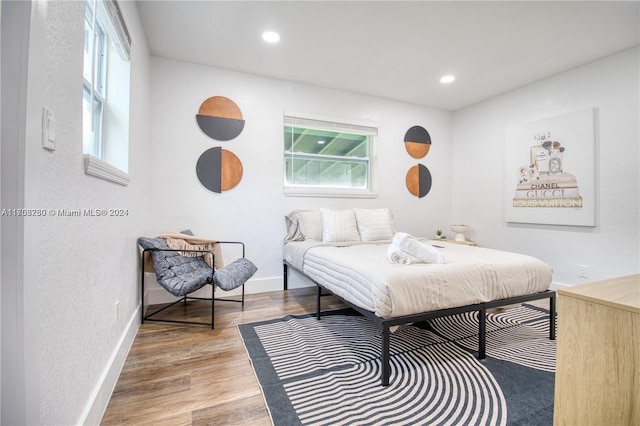 bedroom featuring wood-type flooring and multiple windows