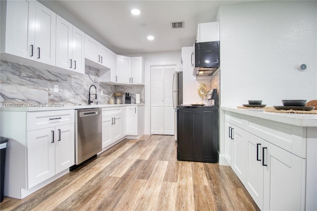 kitchen featuring sink, white cabinetry, stainless steel appliances, and light hardwood / wood-style flooring