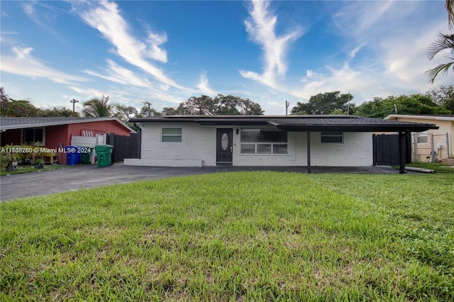 back of property featuring a lawn