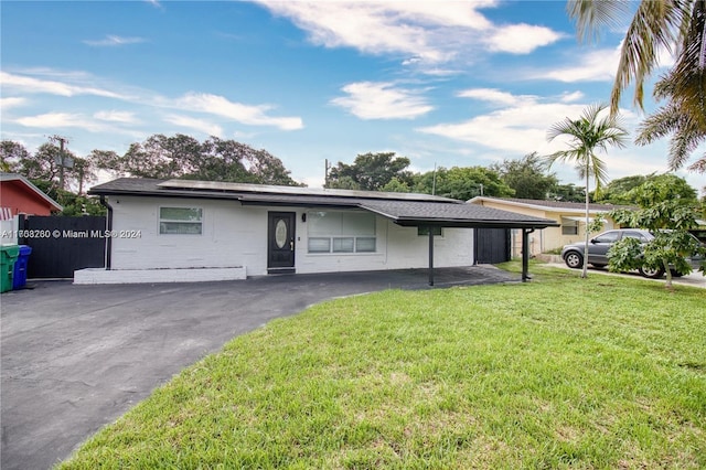 single story home featuring a carport and a front yard