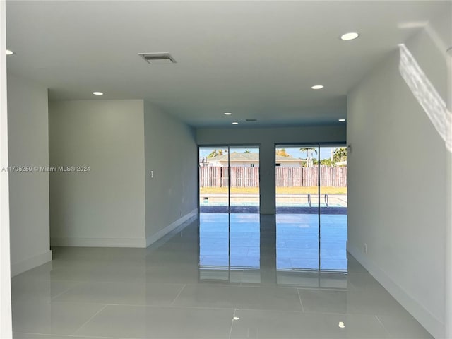 spare room with light tile patterned floors