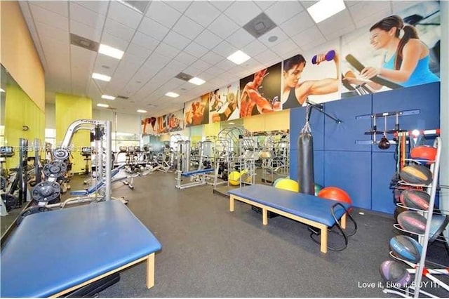 workout area with a paneled ceiling