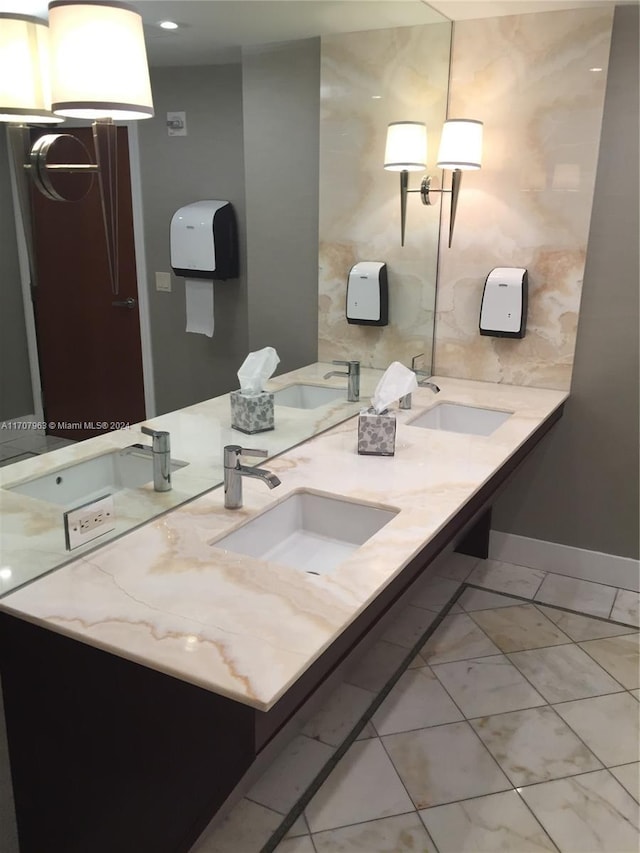 19667 Turnberry Way Unit 15A, Aventura, FL 33180 - bathroom with double vanity and baseboards