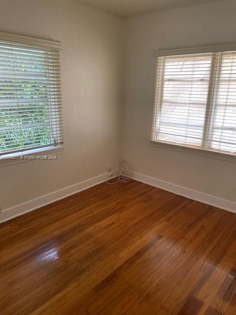 spare room with dark hardwood / wood-style flooring