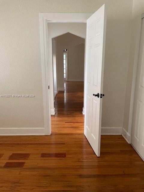 corridor featuring dark hardwood / wood-style floors