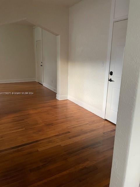 unfurnished room featuring hardwood / wood-style flooring