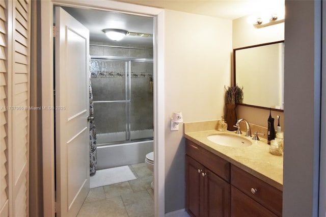 full bathroom with bath / shower combo with glass door, vanity, and toilet