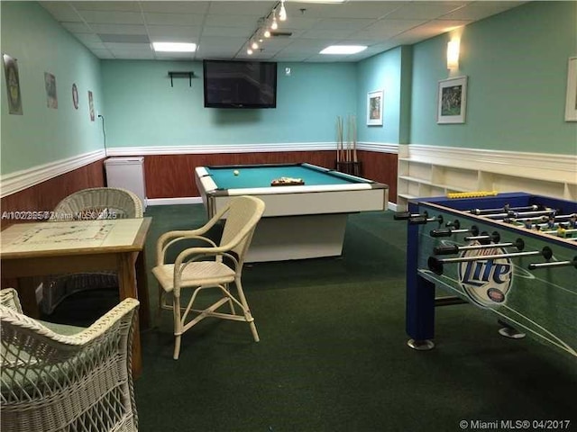 rec room featuring a paneled ceiling, pool table, dark carpet, and wood walls