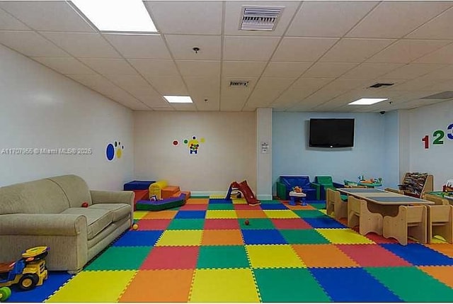 playroom with a paneled ceiling