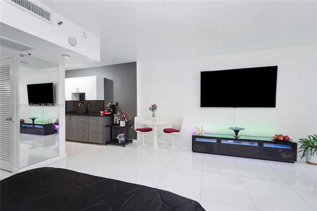 tiled bedroom featuring sink