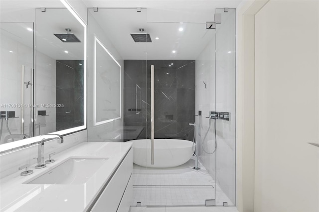 bathroom featuring vanity, shower with separate bathtub, and tile walls