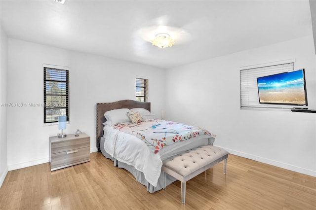 bedroom featuring light hardwood / wood-style flooring and multiple windows