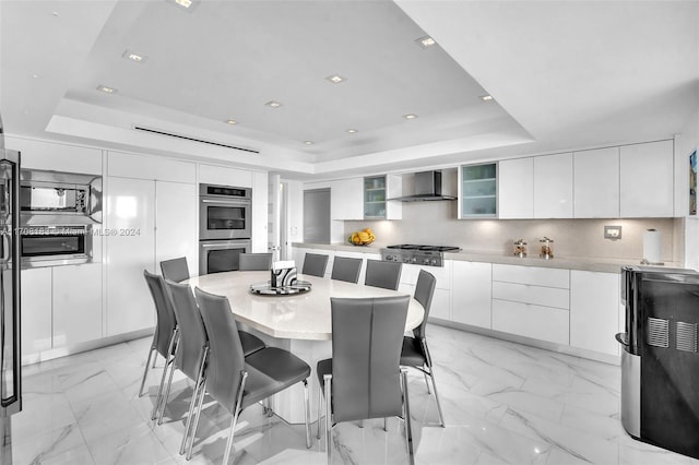 dining room featuring a raised ceiling