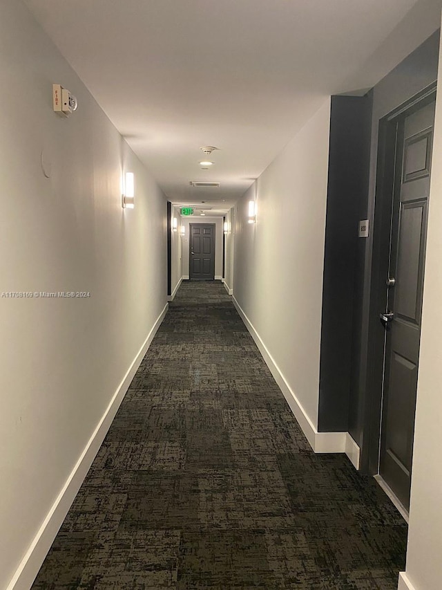 corridor with dark colored carpet