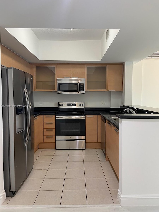 kitchen featuring appliances with stainless steel finishes and light tile patterned floors