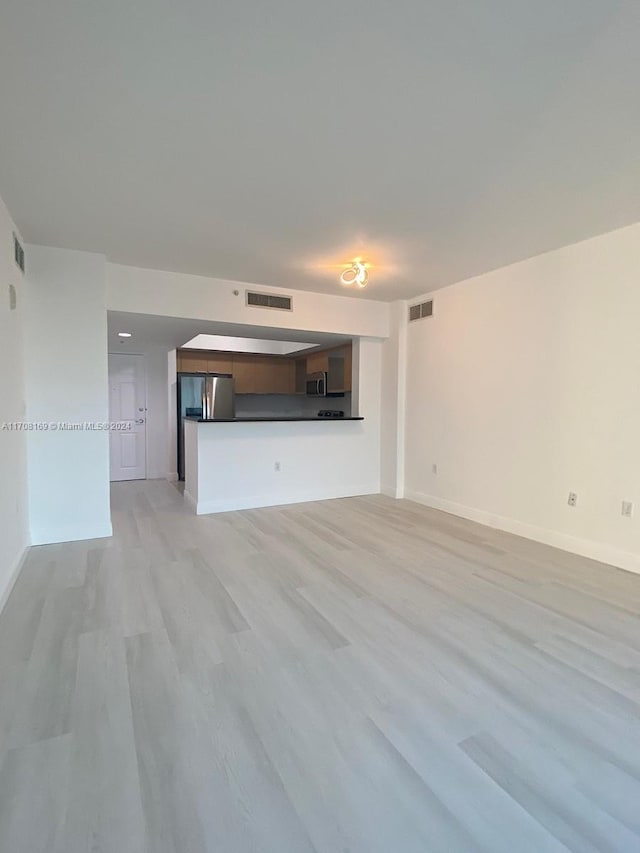 unfurnished living room featuring light wood-type flooring