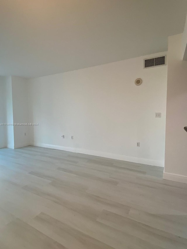 empty room with light hardwood / wood-style flooring