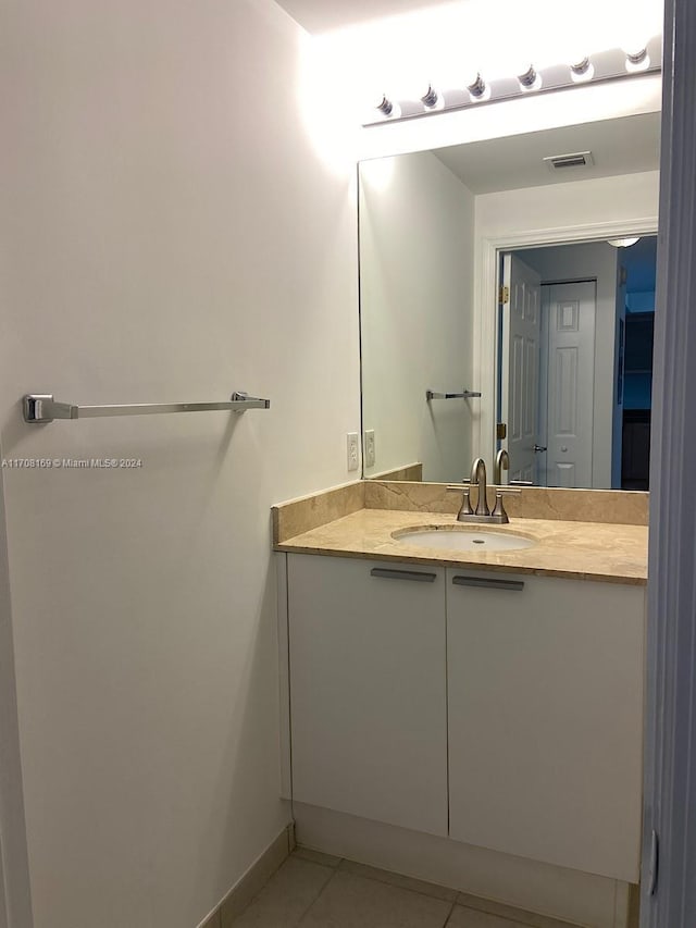 bathroom featuring tile patterned flooring and vanity