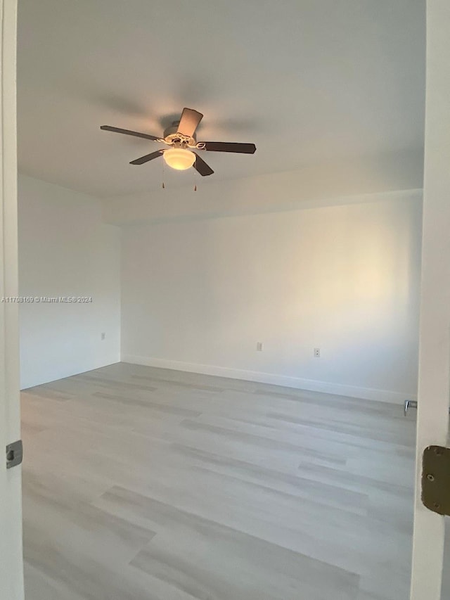 empty room featuring ceiling fan and light wood-type flooring