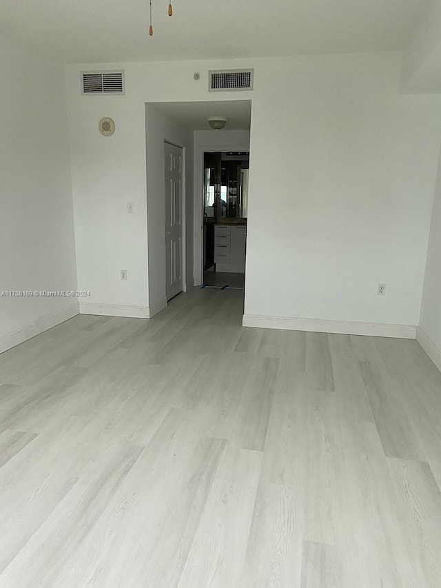 unfurnished room featuring light wood-type flooring