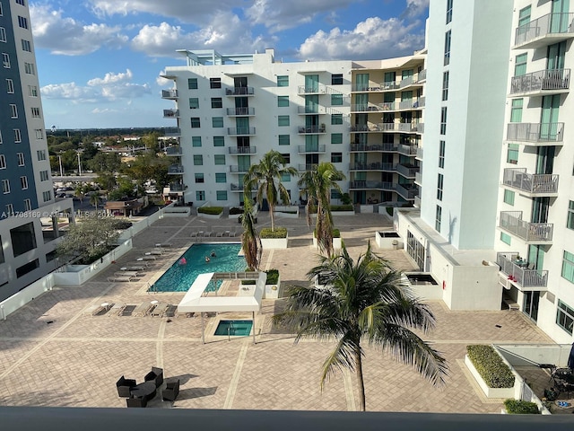 view of building exterior featuring a community pool