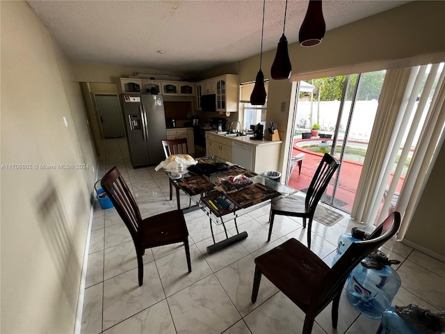 dining room with sink and a textured ceiling