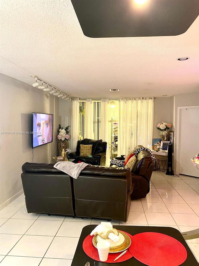 living room with light tile patterned floors and a textured ceiling