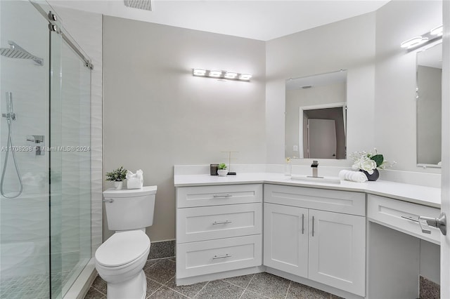 bathroom featuring vanity, an enclosed shower, and toilet