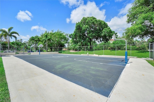 view of sport court featuring a lawn