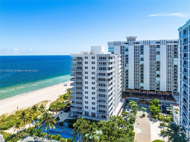 birds eye view of property featuring a beach view and a water view